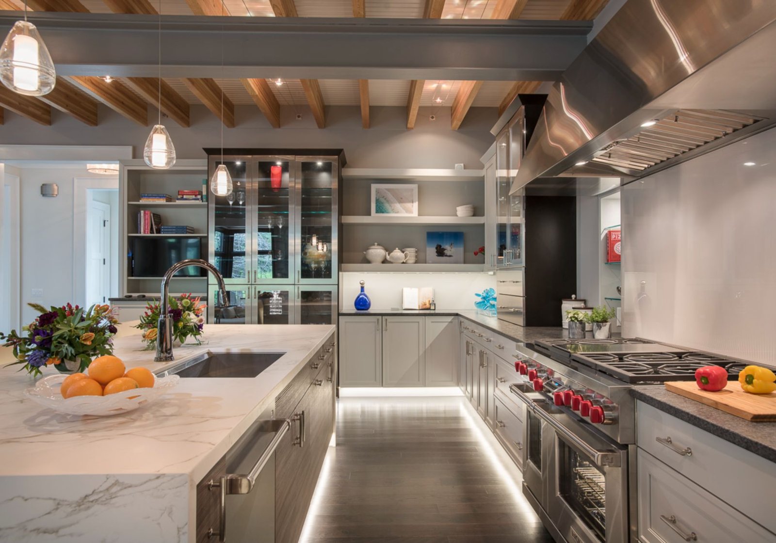 custom home builder Wayne pa - design home studios - underlit cabinets - stainless steel appliances - red stove knobs - exposed beams