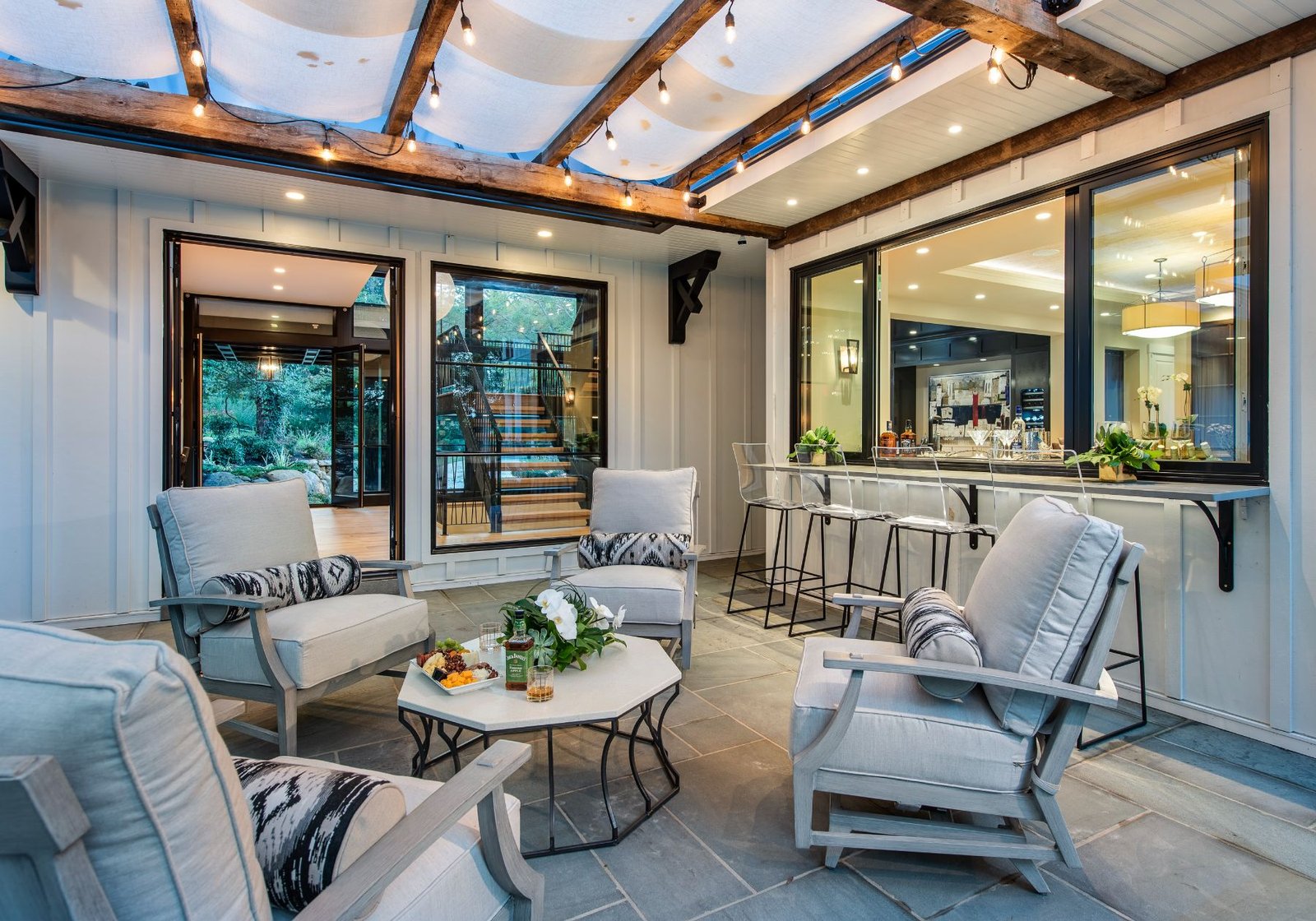 new homes Philadelphia pa - design home studios - modern farmhouse - home exterior patio area - string lights - outdoor bar