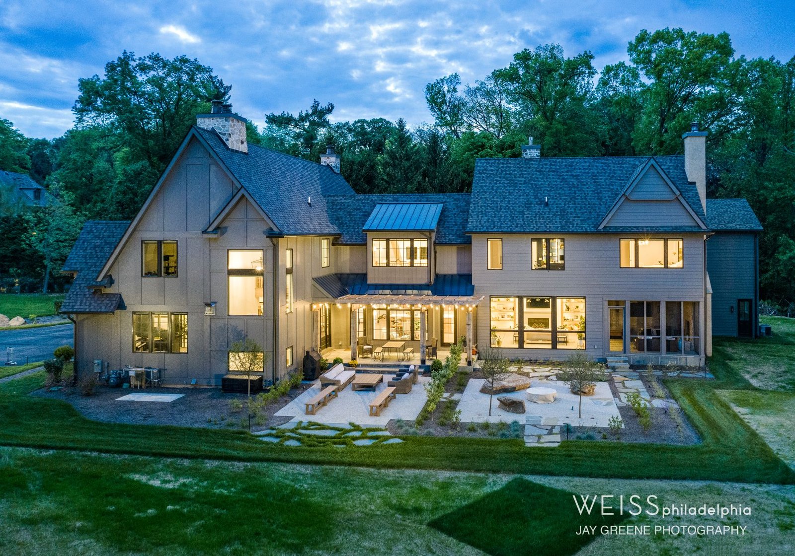 best custom homes wayne pa - design home studios - home exterior - patio area - large windows - grey exterior