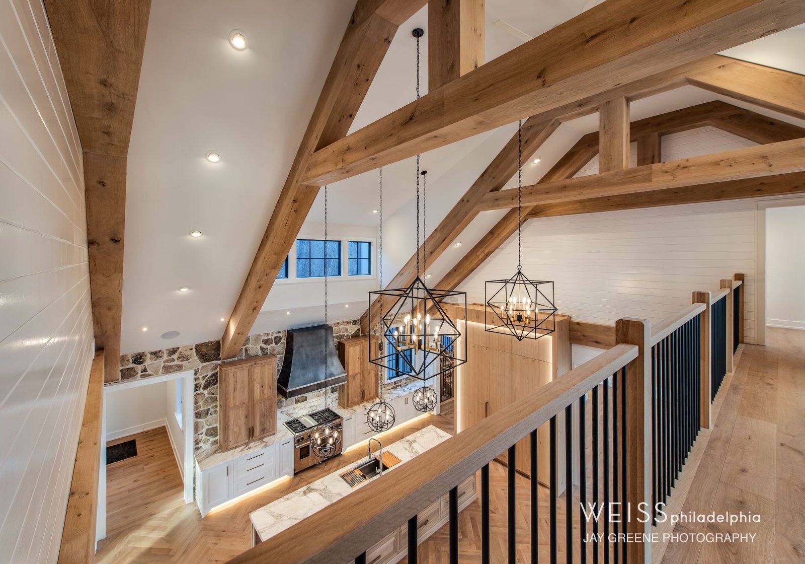 best custom homes wayne pa - design home studios - kitchen - light cabinets white countertops - exposed beams - farmhouse geometric light fixtures