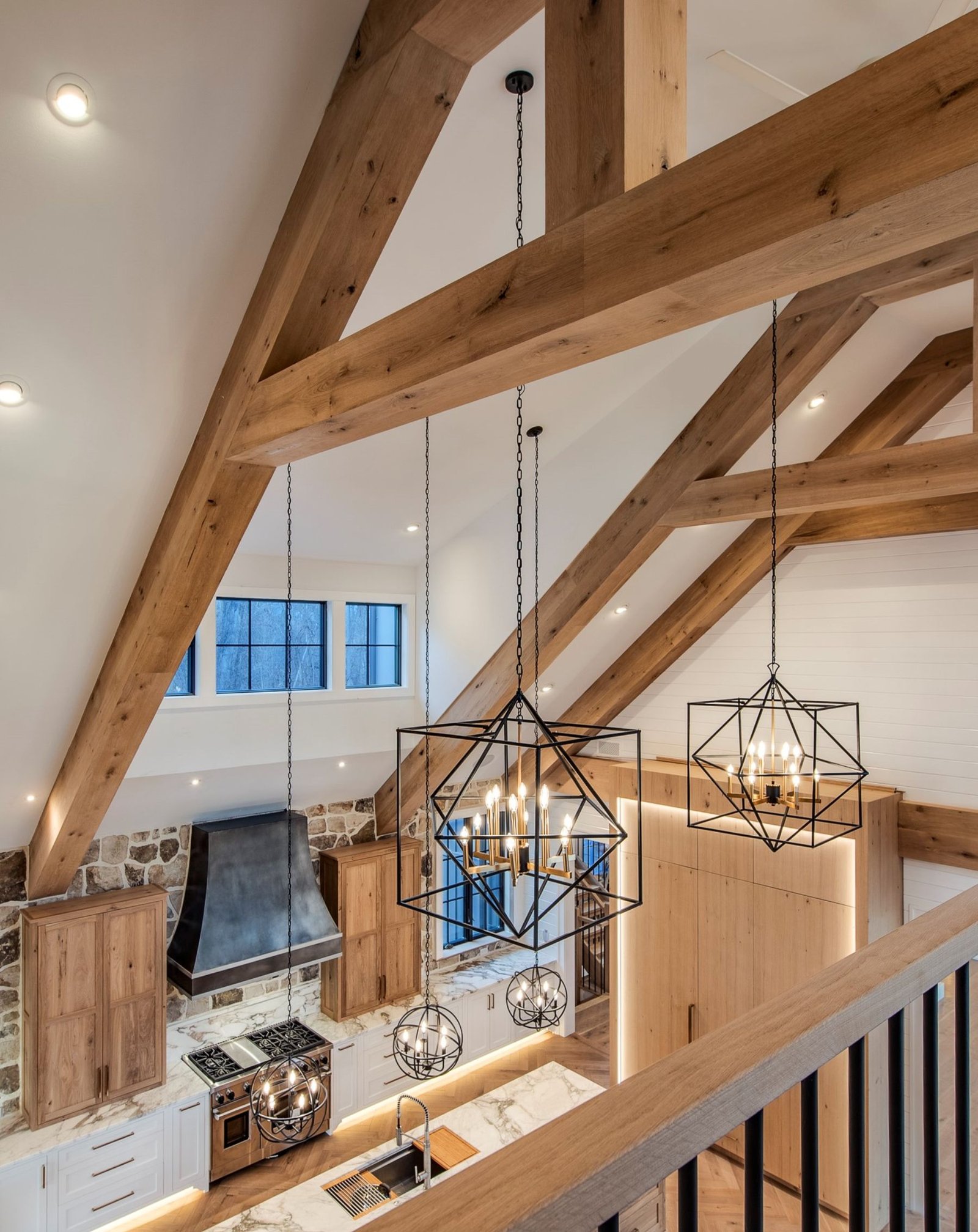 best custom homes wayne pa - design home studios - kitchen - light cabinets white countertops - exposed beams - farmhouse geometric light fixtures
