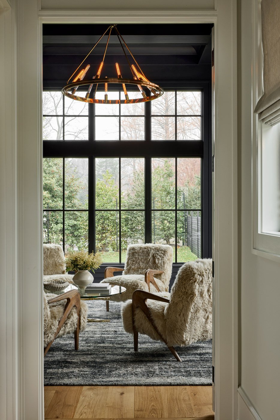 new homes Philadelphia pa - design home studios - lounge room - dark walls - fur chairs - granite fireplace - chandelier