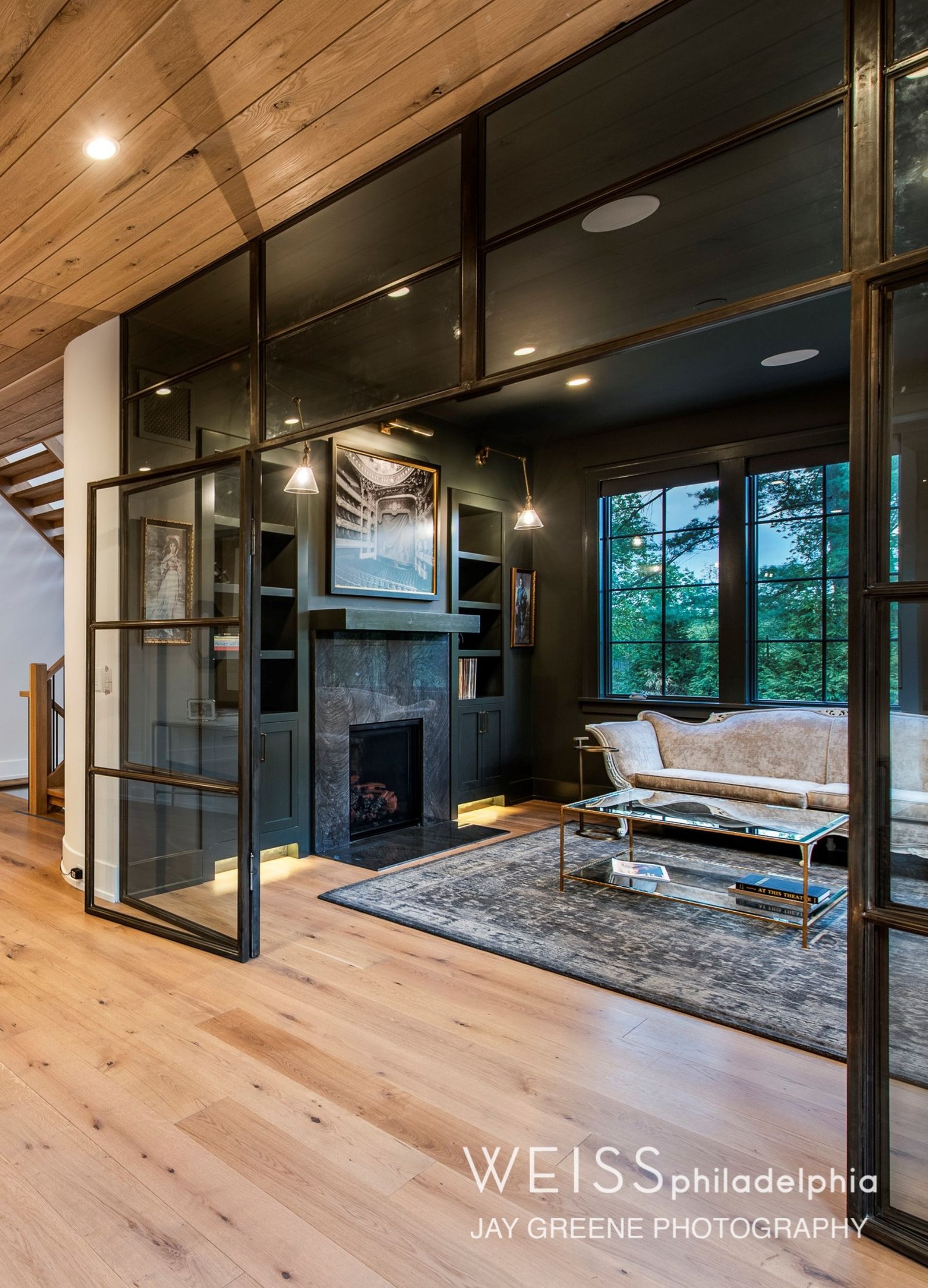 new homes wayne pa - design home studios - glass sitting room - fireplace - white furniture - black walls